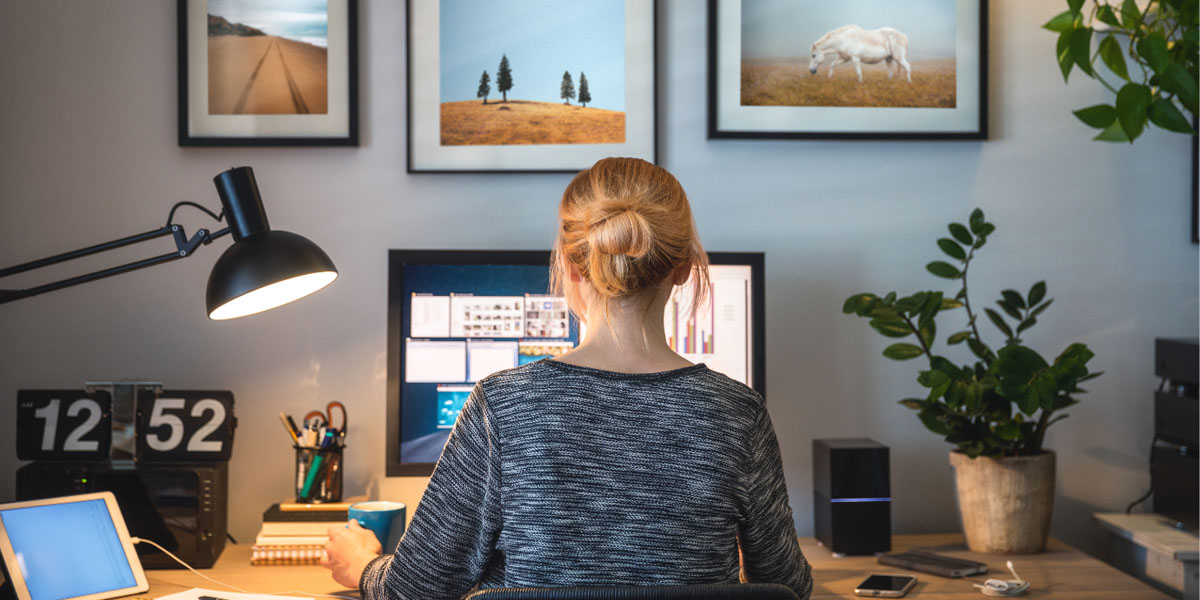 A woman sitting at her desk working from home.